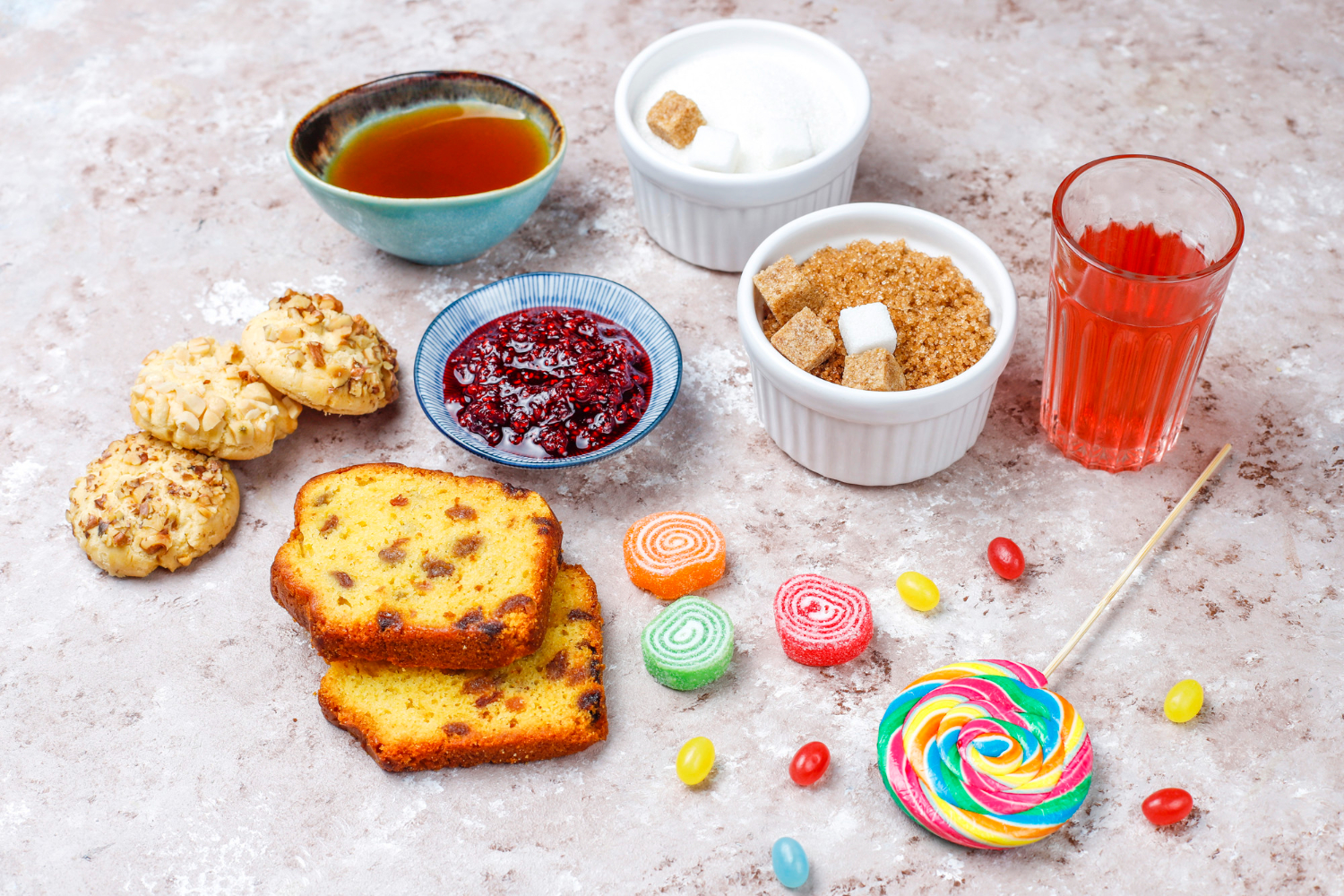 cookies, cake, sugar, jam, sweets, lollipop and other sugary food items on grey table