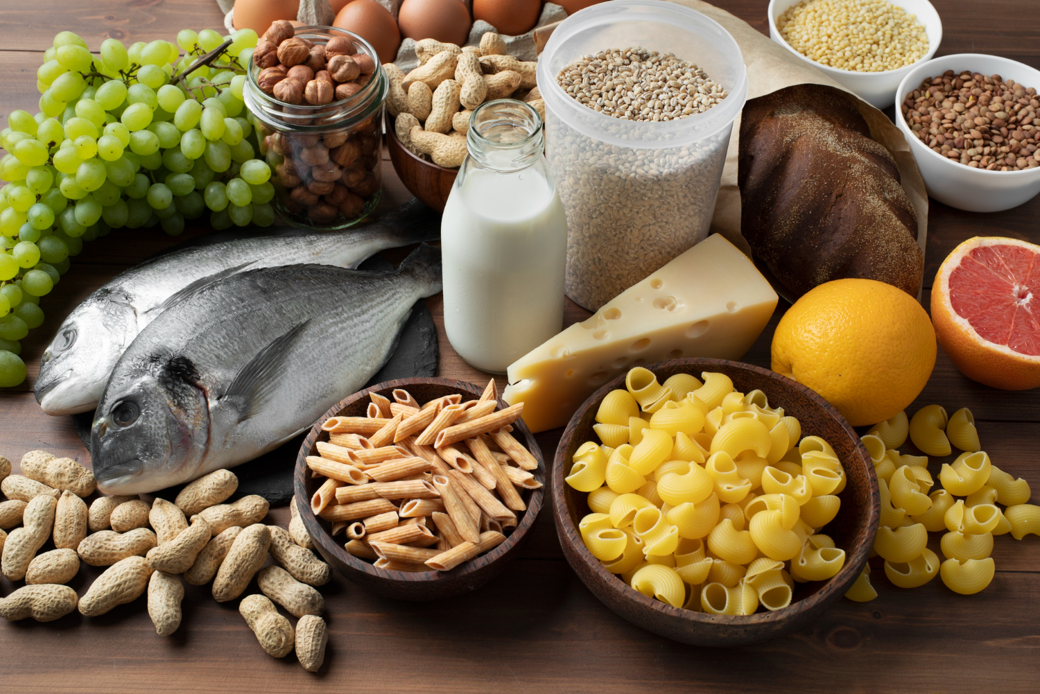 selection of foods that can trigger allergies including fish, pasta, nuts, milk and cheese